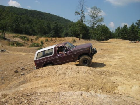 1980 Ford Bronco - This 1980 Ford Bronco navigates a steep incline on a dirt track, its off-road capabilities.