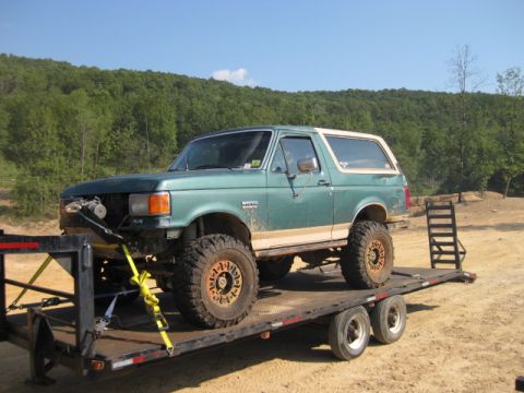 1980 Ford Bronco - Modified Ford Bronco loaded onto a trailer, ready for transport.