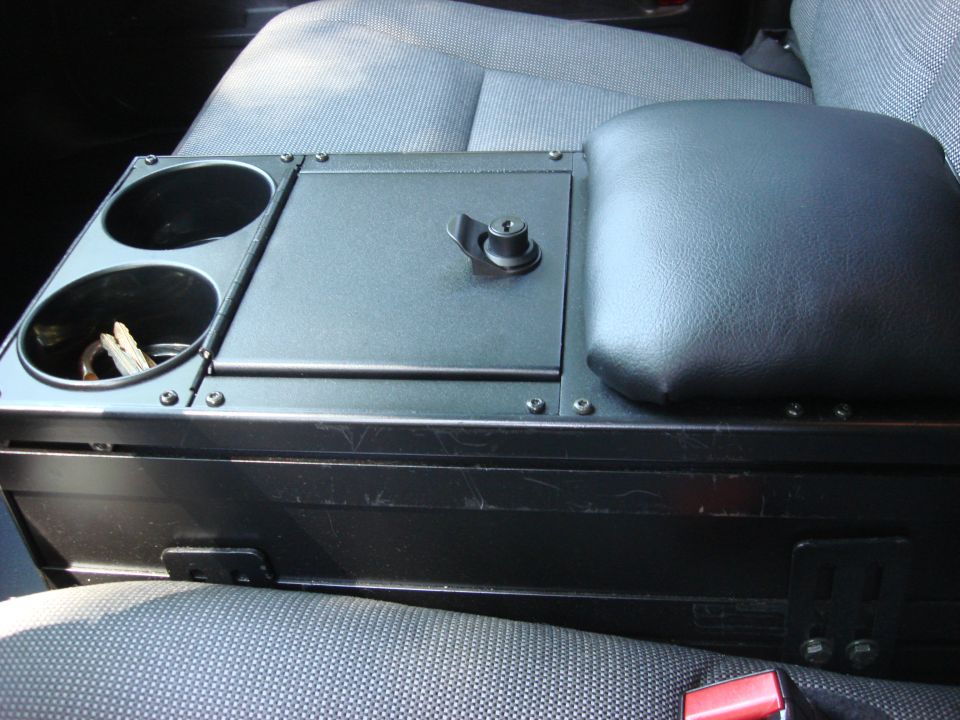 Center console with dual cup holders, lockable compartment, and padded armrest