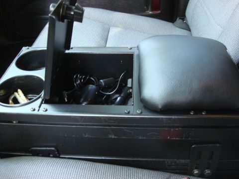 2006 Ford Crown Victoria - Interior view of a car's center console, showing storage, cup holders, and accessories.