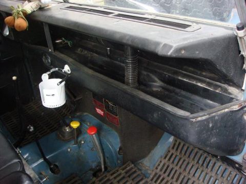 1972 Land Rover Land Rover - The interior of a 1972 Land Rover Land Rover shows a blue dashboard with a black dash tray and floor mats.