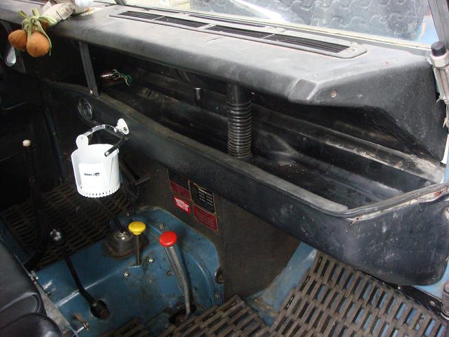 1972 Land Rover Land Rover interior with blue dashboard, black dash tray, and floor mats