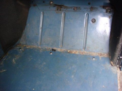 1972 Land Rover Land Rover - Close-up of a blue interior floor panel, showing structural ribs and signs of wear and rust.