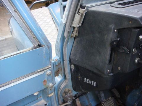 1972 Land Rover Land Rover - The interior of a blue Land Rover shows the dashboard and an open door with a diamond plate step.