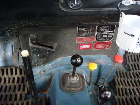1972 Land Rover Land Rover - The interior dashboard of a 1972 Land Rover Land Rover shows multiple gear shifters and informative labels.