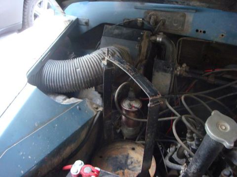 1972 Land Rover Land Rover - Close-up view of the engine bay of a blue vehicle, showing various engine components.