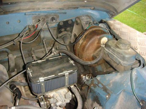 1972 Land Rover Land Rover - The engine bay of a 1972 Land Rover Land Rover shows an aftermarket air filter and brake booster.