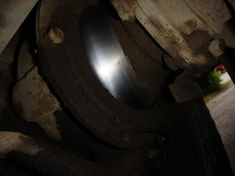 1972 Land Rover Land Rover - Detail of a vehicle's brake rotor and caliper, showing wear and grime.