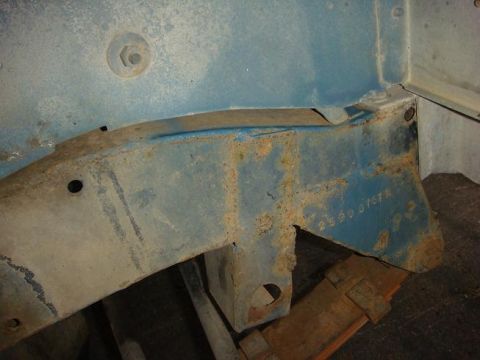 1972 Land Rover Land Rover - A close-up view of a vehicle's frame shows some rust and a stamped identification number.