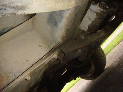 1972 Land Rover Land Rover - The underside of a vehicle shows its frame and suspension parts, with some signs of wear and tear.