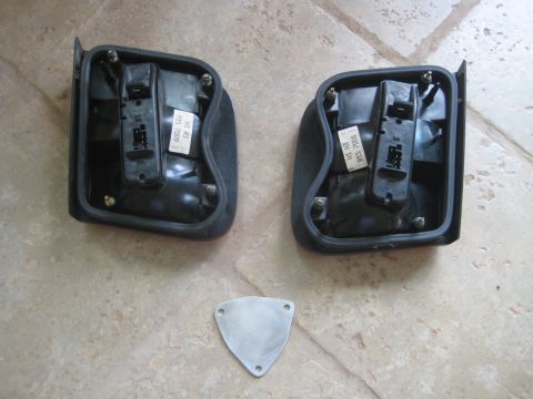 1993 Ford Probe - Two car tail light assemblies and a triangular metal plate are shown on a tiled surface.