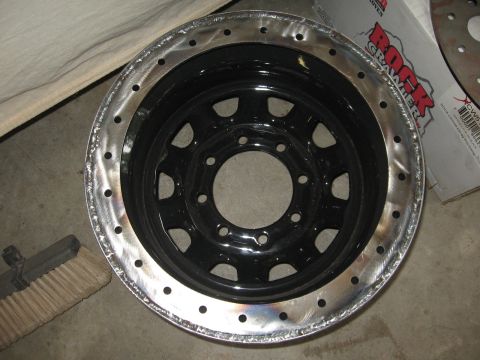 1979 Ford F-150 - A close-up view of a custom-modified wheel rim, showing its black center and polished, bead-locked outer edge.
