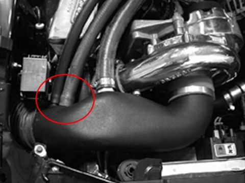 1985 Mercury Grand Marquis - This image shows a close-up view of engine components, focusing on a turbocharger and associated piping.