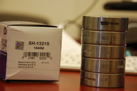1996 Ford Bronco - A box labeled SH-1321S 1845M sits next to a stack of Clevite cam bearings.