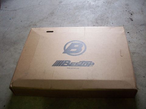 1978 Jeep CJ5 - A closed cardboard box displays the Bestop logo and website, resting on a concrete floor.