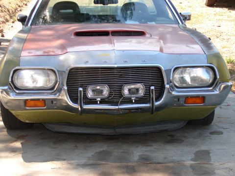 1973 Ford Ranchero - The front of a customized 1972 Ford Ranchero shows a unique paint scheme and auxiliary lights mounted on the bumper.