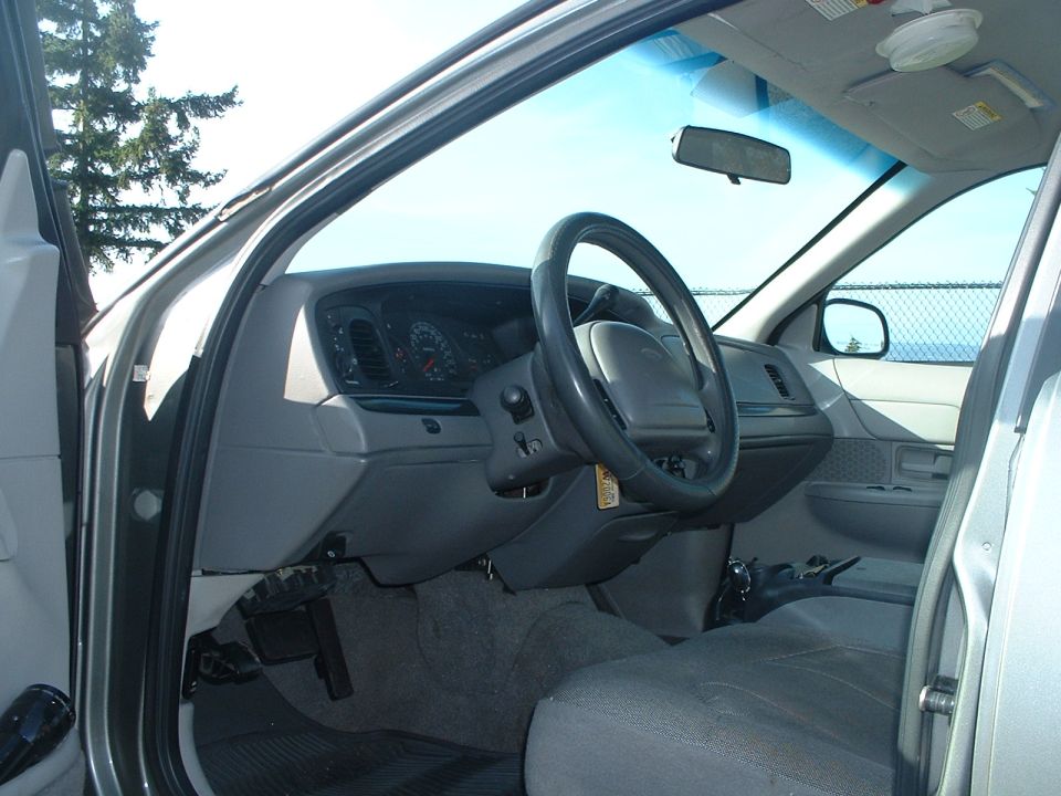 Interior of a 2000 Ford Crown Victoria showing dashboard and steering wheel