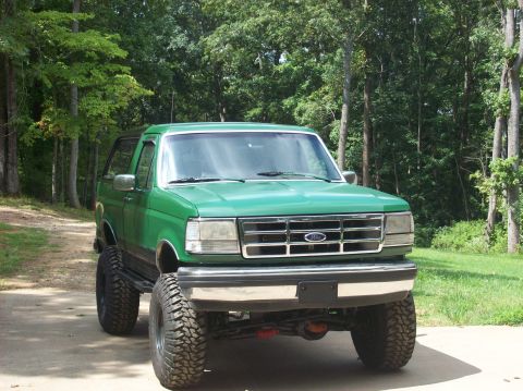 1992 Ford Bronco - This lifted 1992 Ford Bronco presents a commanding presence with its green exterior and stance.