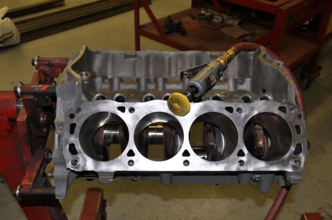 1996 Ford Bronco - Engine block being worked on with an air tool and grinding attachment.