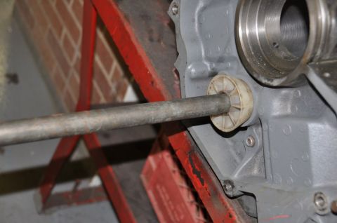 1996 Ford Bronco - Tool inserted into engine block component, likely for bearing work.