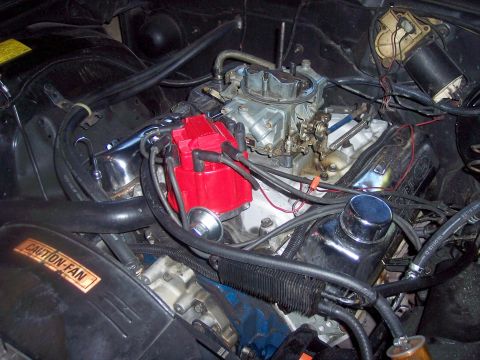 1972 Ford Ranchero - Close-up view of a vehicle's engine bay, focusing on the carburetor and ignition system components.