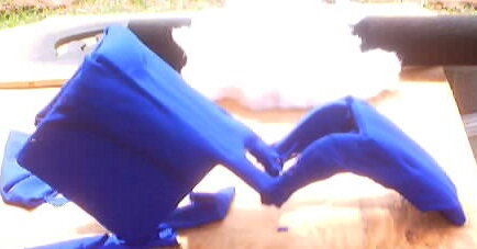 1999 Ford Taurus - Blue fabric is draped over an unidentified car part on a table.
