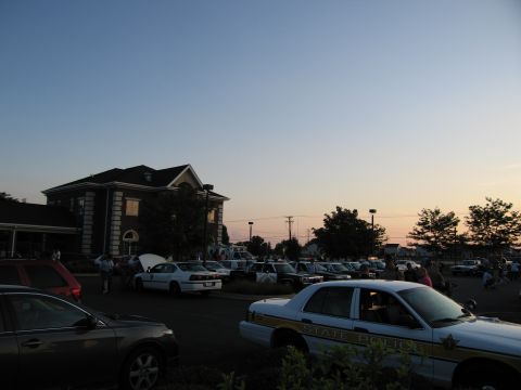1991 Ford Crown Victoria - A white police car with "STATE POLICE" text on its side is parked in a lot with other vehicles during dusk.
