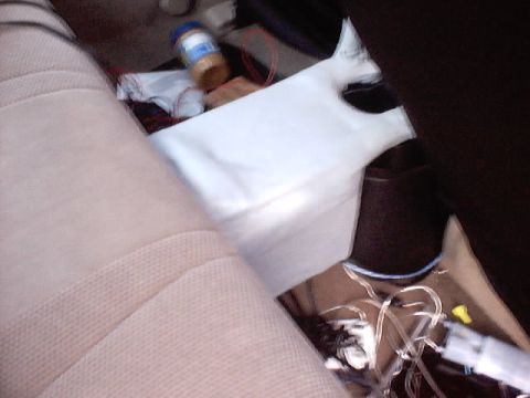 1999 Ford Taurus - A car interior shows a jar of peanut butter and electrical wiring on the floor near the seats.