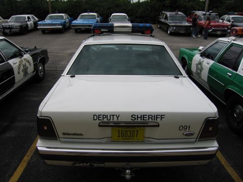 1991 Ford Crown Victoria - Rear view of a 1991 Ford Crown Victoria police car with "DEPUTY SHERIFF" markings and a Florida license plate.