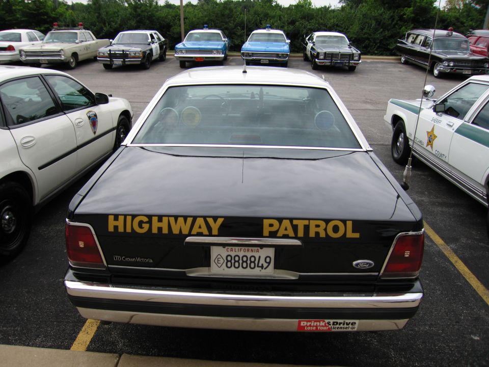 Rear of black Ford LTD Crown Victoria HIGHWAY PATROL car, CA plate 888849