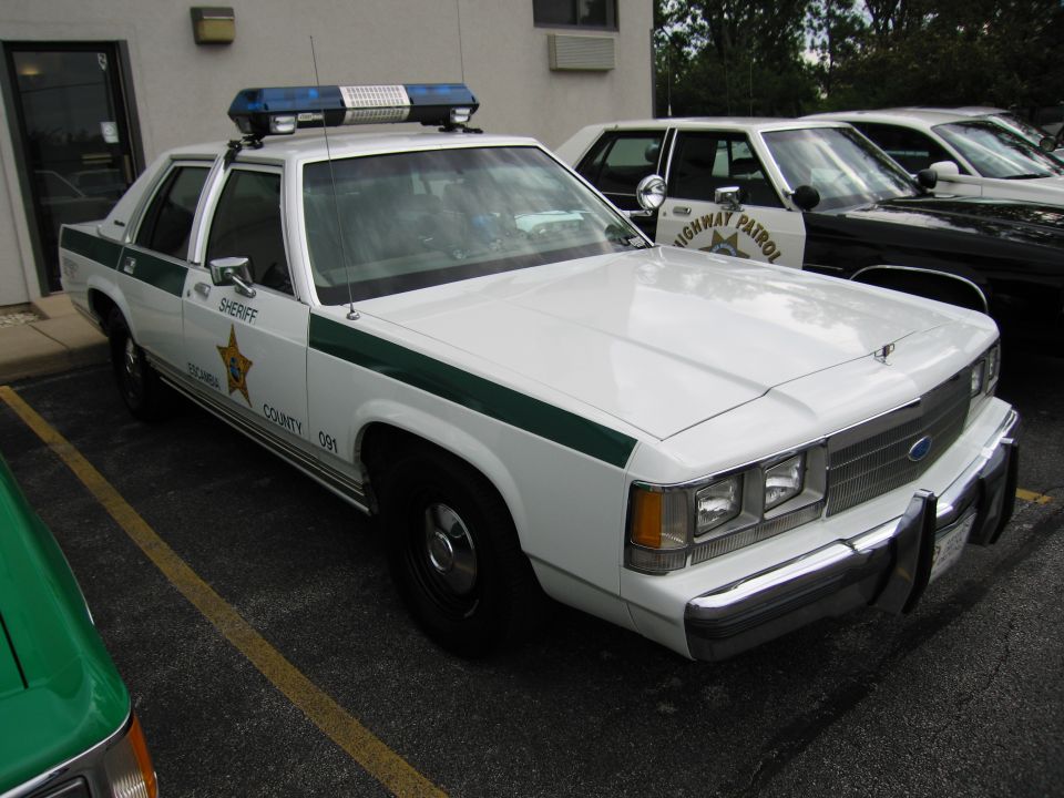 White Sheriff Ford LTD Crown Victoria with green stripe and roof lightbar