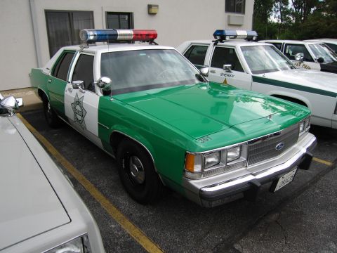 1991 Ford Crown Victoria - This 1991 Ford Crown Victoria police car is parked in a lot with other law enforcement vehicles.