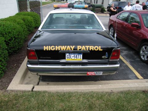 1991 Ford Crown Victoria - Rear view of a 1991 Ford Crown Victoria police car, marked 'HIGHWAY PATROL'.