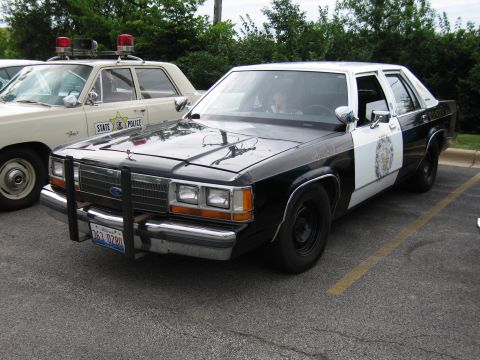 1991 Ford Crown Victoria - A 1991 Ford Crown Victoria police car is parked next to another State Police vehicle.
