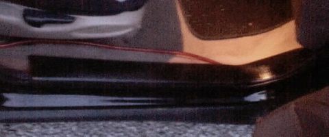 1999 Ford Taurus - Close-up of a car's interior door sill, showing a red wire running along the bottom edge.