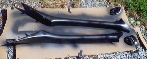 1999 Ford Taurus - Two black interior trim pieces and air vents are shown after being painted.