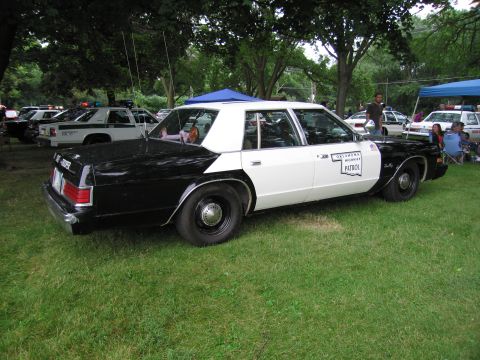 1991 Ford Crown Victoria - This black and white patrol car has 'Oklahoma Highway Patrol' text on its door.