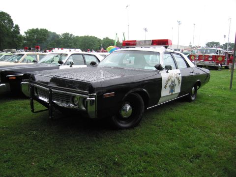 1991 Ford Crown Victoria - A vintage police car with 'Highway Patrol' text on the door is parked on a grassy field.