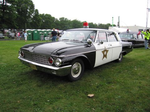 1991 Ford Crown Victoria - This vintage police car, identified by its 'Galaxie' badging, is a stark contrast to the modern vehicles seen in the background.