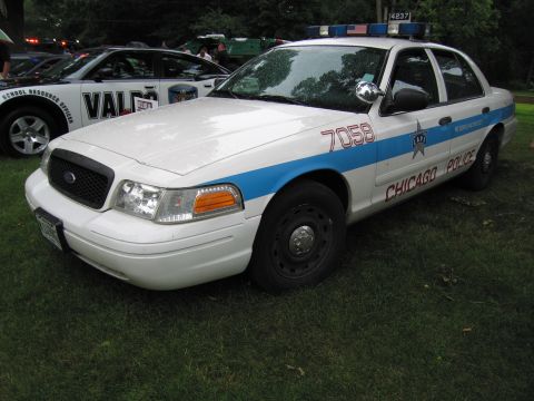 1991 Ford Crown Victoria - A Chicago Police Ford Crown Victoria, marked with unit number 7058, is parked on a grassy area.