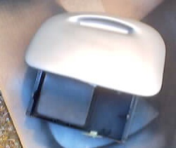 1999 Ford Taurus - A close-up view of a car part, possibly a headlight assembly, with a Supermotors logo visible.