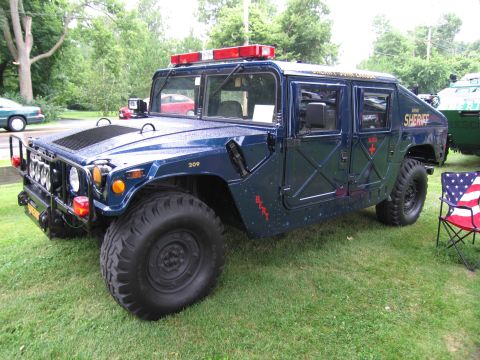 1991 Ford Crown Victoria - A Humvee modified for police use, marked as "SHERIFF" and displaying the number 209.