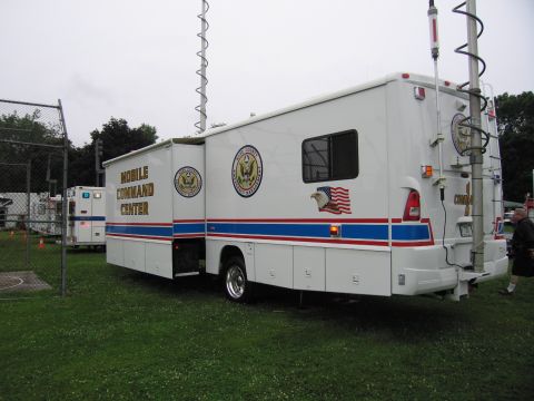 1991 Ford Crown Victoria - A mobile command center vehicle is parked on grass, with another emergency vehicle in the background.