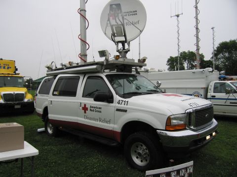 1991 Ford Crown Victoria - A white Ford SUV, marked as American Red Cross Disaster Relief, is parked outdoors with other vehicles.