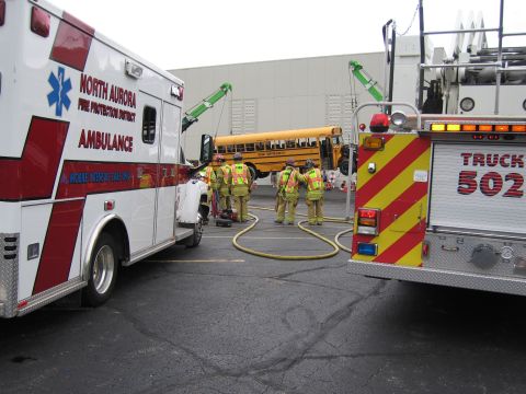 1991 Ford Crown Victoria - Emergency services are on the scene of an incident involving a school bus, with an ambulance and fire truck present.