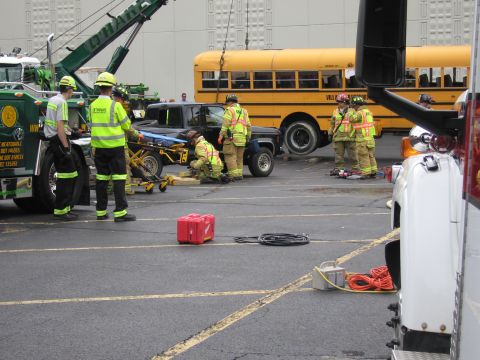 1991 Ford Crown Victoria - Emergency responders are on the scene of an apparent accident involving a car and a school bus.