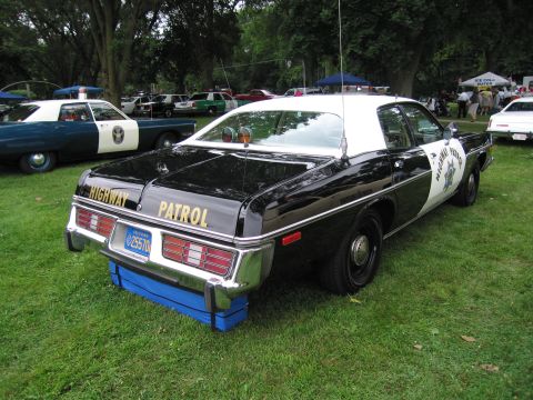 1991 Ford Crown Victoria - This police car is parked on grass with other vehicles in the background.