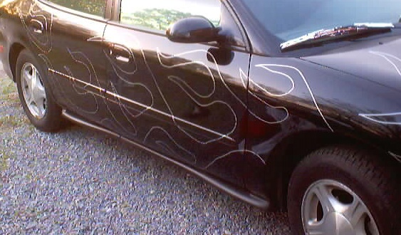 1999 Ford Taurus sedan with silver flame decals on the side
