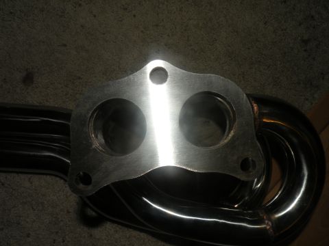 1998 Subaru Legacy - Polished exhaust manifold with a twin-port flange, likely for an aftermarket performance upgrade.