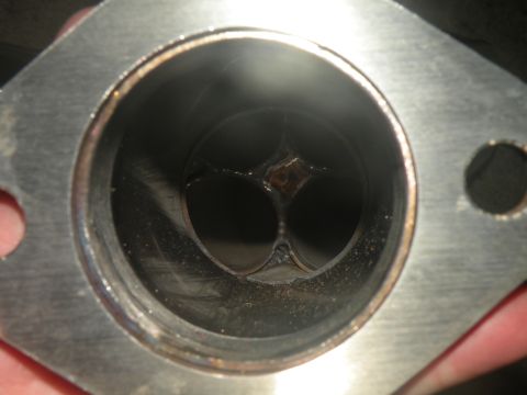 1998 Subaru Legacy - Close-up of an exhaust valve, showing wear and tear from engine operation.